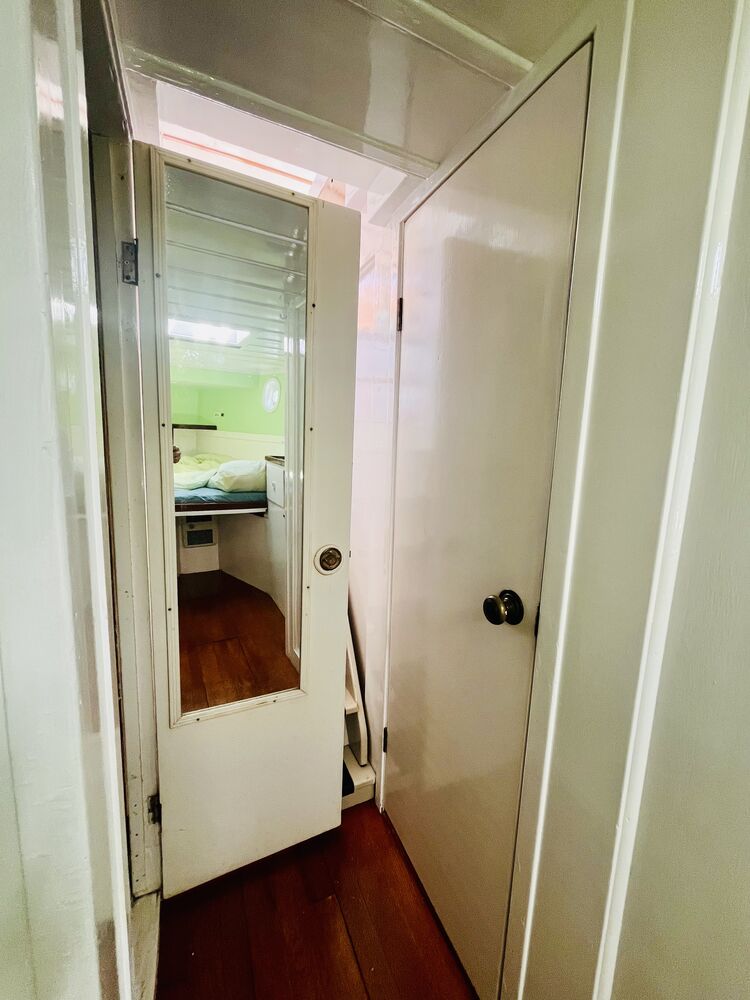 The full-length mirror set into the stateroom door.