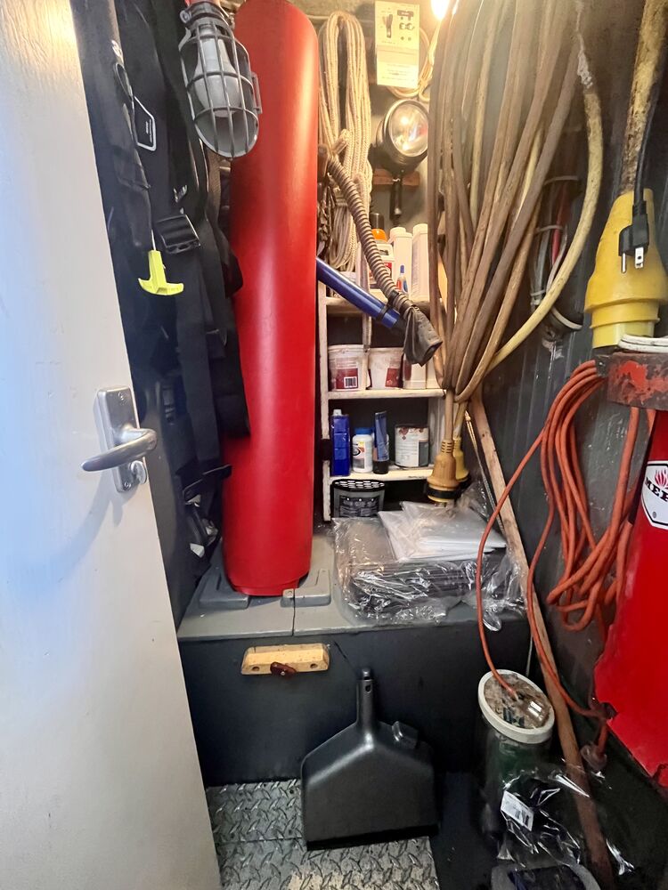 The bosun's locker, with fenders, cordage, tools and spares stowed.